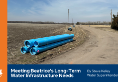 Large blue water main pipes lying along roadway
