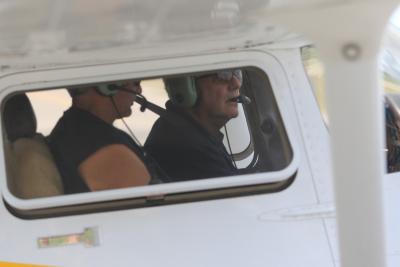 Two men in a plane on runway