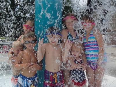 Kid's under fountain at Beatrice Big Blue Water Park
