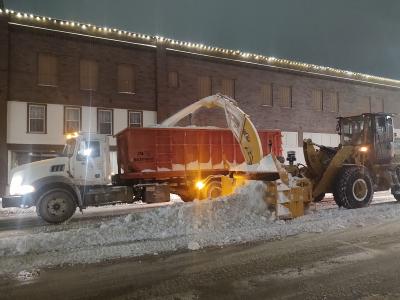 Truck and tractor removing snow from streets